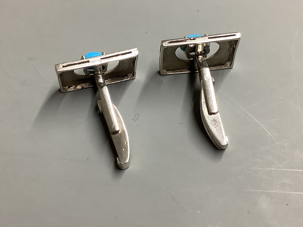 A pair of white metal (tests as 18ct) cufflinks set with turquoise,